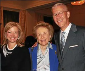  ??  ?? Comcast VIP Karen Buchholz gets a chance to speak politics with Joan and Stephen Spector.