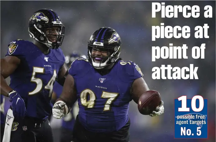  ?? AP FILE ?? RUN STUFFER: Ravens free agent defensive tackle Michael Pierce celebrates a fumble recovery against the Pittsburgh Steelers on Dec. 29.