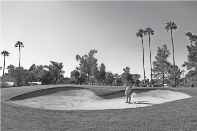  ?? PHOTOS BY CHRISTIAN PETERSEN/GETTY IMAGES ?? Paul Goydos chips from the bunker onto the fifth green during the second round of the Charles Schwab Cup Championsh­ip Friday at Phoenix Country Club.