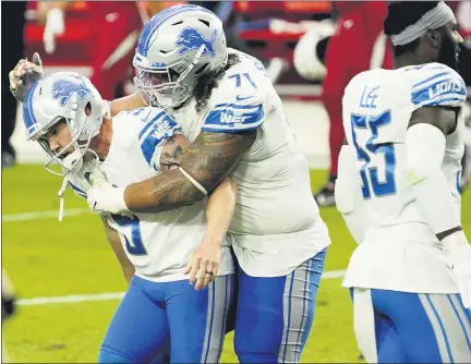  ?? RICK SCUTERI — THE ASSOCIATED PRESS ?? Detroit Lions’ Danny Shelton, center, embraces teammate Matt Prater, left, after Prater kicked the game-winning field goal as time expired against the Arizona Cardinals on Sunday. The Lions edged the Cardinals, 26-23, to end an 11-game losing streak going back to last season.