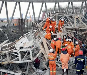  ?? AFP ?? Rescue workers look for survivors after a platform collapsed at the Fengcheng power plant in eastern China’s Jiangxi Province on Thursday. —