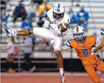  ?? STAFF PHOTO BY ROBIN RUDD ?? Heritage’s Ryan Carter, left, goes up for a reception against Northwest’s Daylin Young on Friday at Northwest Whitfield.