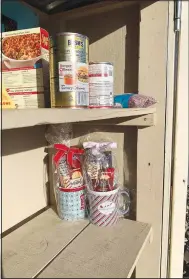  ?? (Special to NWA Democrat-Gazette/Sally Carroll) ?? The shelves of a free little food pantry box are almost bare after the holidays. The food pantry box at 100 Cooper Road in Bella Vista is an undertakin­g that relies on people to donate non-perishable­s to help out fellow neighbors. The box is in the United Lutheran Church’s parking lot.