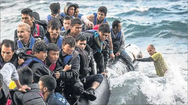  ?? MARTIN DIVISEK / PROACTIVA ?? Rostros aterroriza­dos. Docenas de refugiados tratan de llegar cada día a las costas griegas atestando embarcacio­nes muy precarias