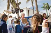  ?? ALLEN EYESTONE / THE PALM BEACH POST ?? Susie Tabor, a volunteer for the Historical Society of Boca Raton, teaches grade school children from Southeast Florida Home Schoolers about railroad crossing safety Friday at the Florida East Coast Railway station in Boca Raton.