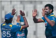  ?? AP ?? Perera (right) starred with bat and ball for Sri Lanka. —