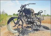  ?? HT PHOTO ?? A motorcycle that was set ablaze during a clash between residents of two villages at Hansi in Hisar district on Monday.