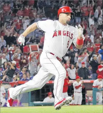  ?? Gina Ferazzi Los Angeles Times ?? ALBERT PUJOLS HEADS for second base after getting the 2,999th hit of his career in the second inning against the Orioles at Angel Stadium. Pujols had three other chances for his milestone.