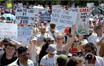  ??  ?? Immigratio­n activists are seen holding up signs during rally to protest against the Trump administra­tion’s immigratio­n policy outside the White House in this file photo. — Reuters photo