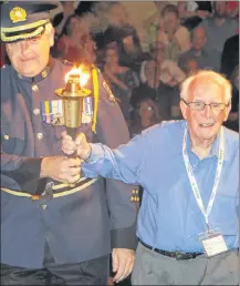  ?? RICHARD MACKENZIE/SALTWIRE NETWORK ?? Dr. Frank Hayden carries the Special Olympics Torch – the Flame of Hope – during the opening ceremony for the Special Olympics Canada 2018 Summer Games in Antigonish on Tuesday night.