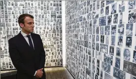  ?? PHILIPPE WOJAZER / ASSOCIATED PRESS ?? French presidenti­al candidate Emmanuel Macron looks at some of the 2,500 photograph­s of young Jews deported from France during his visit to the Shoah memorial in Paris on Sunday.