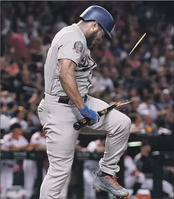  ?? Jennifer Stewart Getty Images ?? IN A SIGN of the Dodgers’ frustratio­n Wednesday night, Yasiel Puig breaks his bat after flying out in the fifth inning. The Dodgers had one baserunner after Cody Bellinger’s single in the fifth.