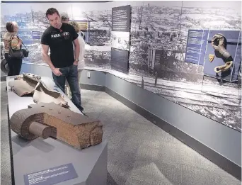  ??  ?? Artifacts from the Halifax Explosion are viewed by visitors to the Maritime Museum of the Atlantic in Halifax.