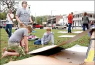  ?? Janelle Jessen/Herald-Leader ?? A group of boys from Compass Church Youth Group worked to build a shelter out of cardboard boxes to sleep in on Friday night.