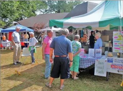  ?? LAUREN HALLIGAN - MEDIANEWS GROUP ?? Eventgoers check out different booths at the 2019 Saratoga Peace Fair on Sunday afternoon in Saratoga Springs.