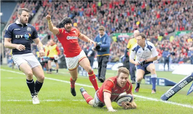  ??  ?? Liam Williams crashes over for one of his four tries for Wales over the course of the 2016/17 season