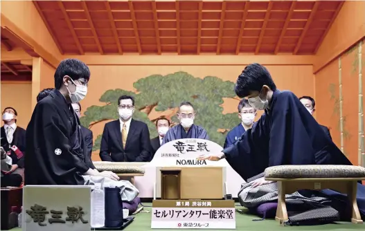  ?? The Yomiuri Shimbun ?? Sota Fujii, right, moves a piece during the first match in a best-of-seven series against eighth-dan challenger Akihito Hirose at the 35th Ryuo shogi tournament in Shibuya Ward, Tokyo, on Oct. 7.