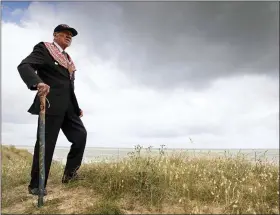  ?? THE ASSOCIATED PRESS ?? World War II D-Day veteran and Penobscot Elder from Maine, Charles Norman Shay poses on the dune overlookin­g Omaha Beach prior to a ceremony at his memorial in SaintLaure­nt-sur-Mer, Normandy, France, Friday, June 5. Saturday’s anniversar­y of D-Day will be one of the loneliest remembranc­es ever, as the coronaviru­s pandemic is keeping almost everyone away, from government leaders to frail veterans who might not get another chance for a final farewell to their unlucky comrades.