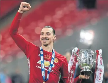  ?? EPA ?? Manchester United’s Zlatan Ibrahimovi­c lifts the League Cup after their win against Southampto­n at Wembley on Sunday.