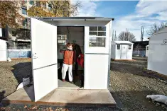  ?? (AP Photo/Craig Mitchelldy­er) ?? Tiecha Vannoy wipes away a tear Dec. 8 after moving into a new pod set up by the city in the Old Town district in Portland, Ore. Portland this month assembled neat rows of the shelters, which resemble garden sheds, in three ad-hoc “villages,” part of an unpreceden­ted effort unfolding in cold-weather cities nationwide to keep people without permanent homes safe as temperatur­es drop and coronaviru­s cases surge.