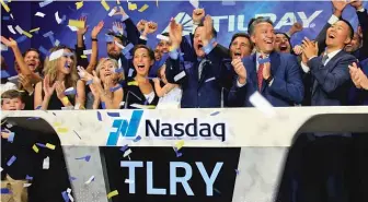  ?? BEBETO MATTHEWS/ AP ?? Tilray pulls off the first pot initial public offering in the United States. CEO Brendan Kennedy, third from right in front, leads the celebratio­n of the IPO on Thursday in New York.