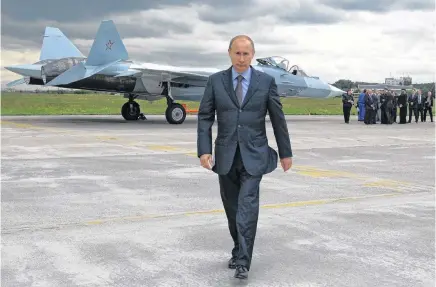  ?? ALEXEI DRUZHININ
AP ?? Russian Prime Minister Vladimir Putin walks after inspecting a new Russian fighter jet after its test flight in Zhukovksy, outside Moscow, Russia, on June 17, 2010. •