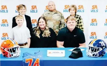  ?? ?? Starkville Academy offensive lineman Jacob Hemphill, seated right, celebrates his signing with Northeast Mississipp­i Community College with his family Wednesday morning. (Submitted photo)