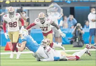  ?? JAE C. HONG — THE ASSOCIATED PRESS ?? Los Angeles Chargers quarterbac­k Easton Stick (2) is tackled by 49ers defensive end Arik Armstead during the first half of Sunday’s preseason game at SoFi Stadium in Inglewood.