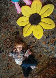  ?? ?? Sofia, 4, lies next to a sunflower, the Ukrainian symbol for peace.