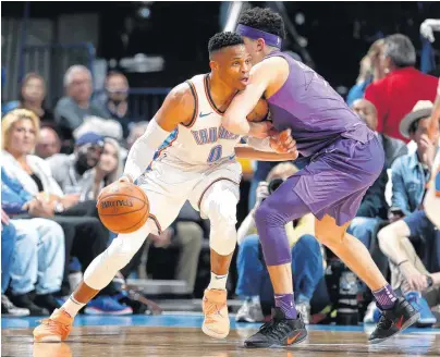  ?? [PHOTO BY SARAH PHIPPS, THE OKLAHOMAN] ?? Oklahoma City’s Russell Westbrook tries to get around Phoenix’s Devin Booker during Thursday’s game at Chesapeake Energy Arena.