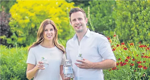  ??  ?? CHEERS: Nick and Emma Smalley, whose gin themed on Aberdeensh­ire’s tea trade has won both silver and bronze medals from judges