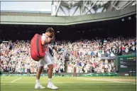  ?? Pool / Getty Images ?? Roger Federer of Switzerlan­d walks off court after losing to Hubert Hurkacz during the quarterfin­als at Wimbledon on Wednesday.