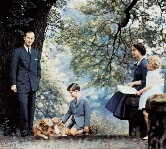  ??  ?? Proud parents: with Prince Charles and Princess Anne in the grounds of Buckingham Palace in 1957