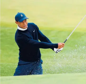  ?? ANDREW REDINGTON/GETTY ?? Tiger Woods warms up on the range during a practice round Tuesday in Augusta, Georgia.