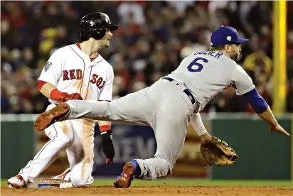  ?? AP Photo/Matt Slocum ?? Q Boston Red Sox’s Andrew Benintendi is out at second as Los Angeles Dodgers’ Danny Lehmann turns a double play during the third inning of Game 1 of the World Series on Tuesday in Boston.