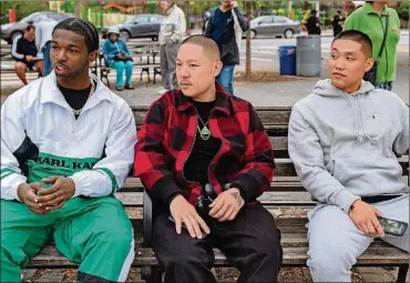  ?? NICOLE RIVELLI/FOCUS FEATURES ?? Actor Pop Smoke (from left), director Eddie Huang and actor Taylor Takahashi on the set of their film “Boogie,” in theaters today.