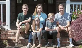  ??  ?? Dr. Charissa Pacella, chief of emergency medicine at UPMC Presbyteri­an Hospital, sits with her children, from left, Justin, 19, Michaela, 10, Gabe, 13, and Nick, 17, on Monday outside their home in Upper St. Clair.