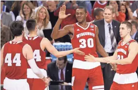  ?? GETTY IMAGES ?? Wisconsin’s Frank Kaminsky (from left), Bronson Koenig, Vitto Brown and Josh Gasser celebrate at the end of the first half against Kentucky during the 2015 Final Four.