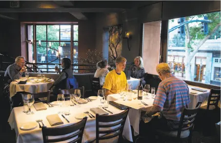  ?? PHOTOS BY LAURA MORTON ?? Above: Visitors to Oliveto have dinner in the main dining room at the restaurant in the landmark Rockridge Market Hall, which has been in business for more than 30 years. Below: The English pea gnocchetti with Dungeness crab, English peas and chervil...