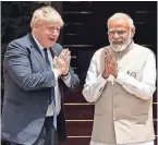  ?? STEFAN ROUSSEAU/POOL/AFP VIA GETTY IMAGES ?? British Prime Minister Boris Johnson, left, and Indian Prime Minister Narendra Modi greet each other before Friday’s meeting in New Delhi.