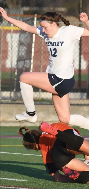  ?? KEN SWART — FOR MEDIANEWS GROUP ?? Berkley’s Maeve Nolan, top, puts the pressure on Brimingham Seaholm goalkeeper Sydney Ryan during the OAA White matchup on Tuesday at Seaholm. Nolan came up with the game-winning goal in the Bears’ 3-1win. The match was knotted up at 1-1at one point before Berkley pulled away.