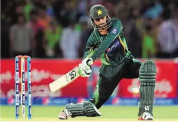  ?? AFP ?? A big hit Pakistani batsman Shoaib Malek plays a shot during his century in the first One Day Internatio­nal against Zimbabwe at the Gaddafi Cricket Stadium in Lahore yesterday.