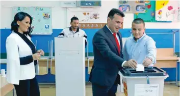  ?? — Reuters ?? Macedonia’s Prime Minister Zoran Zaev, his wife Zorica and son Dushko cast their ballot in Strumica on Sunday.