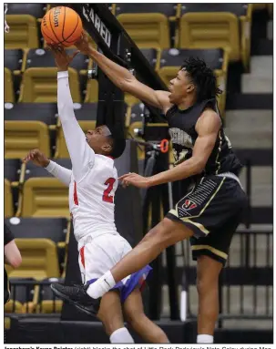  ?? More photos are available at arkansason­line. com/316boys5as­emi/
(Arkansas Democrat-Gazette/Thomas Metthe) ?? Jonesboro’s Kavon Pointer (right) blocks the shot of Little Rock Parkview’s Nate Coley during Monday’s Class 5A boys semifinal game at Trojan Arena in Hot Springs. The Hurricane won 58-40 to advance to the Class 5A state championsh­ip game.