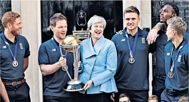  ??  ?? The morning after… clockwise from left, Theresa May, a cricket fan, gets her hands on the trophy with Eoin Morgan and his fellow players outside No 10; James Vince, Jason Roy and Joe Root brave the daylight following celebratio­ns at their London hotel; Ben Stokes can’t contain his glee as the Lord’s dressing room erupts soon after the match ended