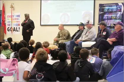  ?? (Matt Hutcheson/News-Times) ?? The Rev. Eddie Morgan, standing, was one of several veterans who spoke with Yocum Primary School students on Friday.
