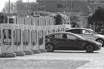  ?? Justin Sullivan / Tribune News Service ?? A Tesla car recharges its battery in Petaluma, Calif. Electric vehicles accounted for 4.2 percent of U.S. new vehicle sales in the first quarter of this year.