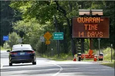  ?? ROBERT F. BUKATY - THE ASSOCIATED PRESS ?? In this Wednesday, June 10photo, a sign in Gilead, Maine, near the border with New Hampshire, warns visitors entering Maine that they are required to quarantine for 14 days. Residents of New Hampshire and Vermont are exempt.