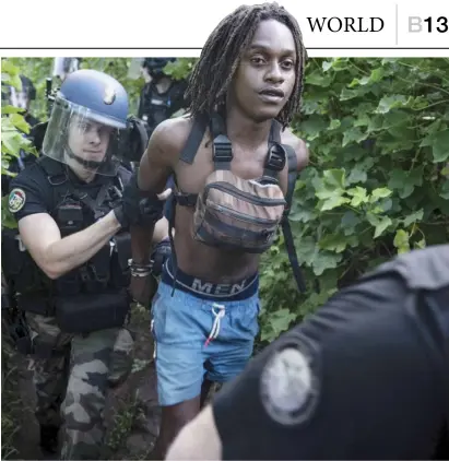  ?? JULIEN DE ROSA/AGENCE FRANCE-PRESSE ?? GENDARMES arrest a young boy during a security operation in a shantytown of Koungou on Mayotte island, a territory of France in the Indian Ocean.