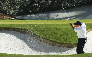  ?? Associated Press photo ?? Phil Mickelson hits from a bunker on the 12th hole during the third round of the Masters golf tournament, Saturday, in Augusta, Ga.